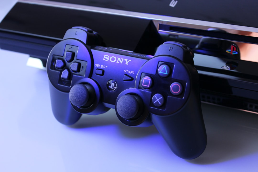 black Sony PS2 controller on white surface - unsplash