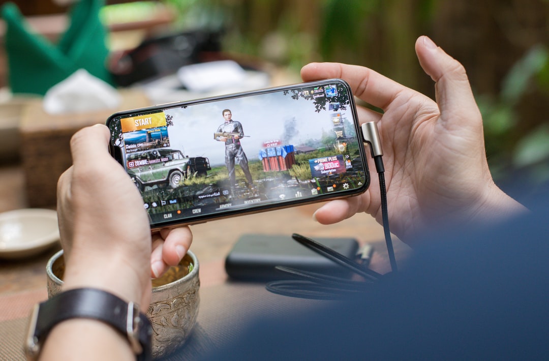 person playing PUBG mobile - Playing Pubg Game On Smartphone, tags: world invitational 2022 - unsplash